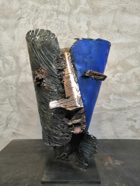 sculpture in metal and bronze by julien allegre representing a blue mask